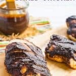 A sliced chicken breast covered with barbecue sauce on a cutting board with text overlay that says "Balsamic BBQ Baked Chicken".