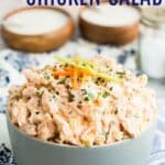 A bowl of chicken salad garnished with celery and carrots with text overlay that says "Buffalo Chicken Salad".