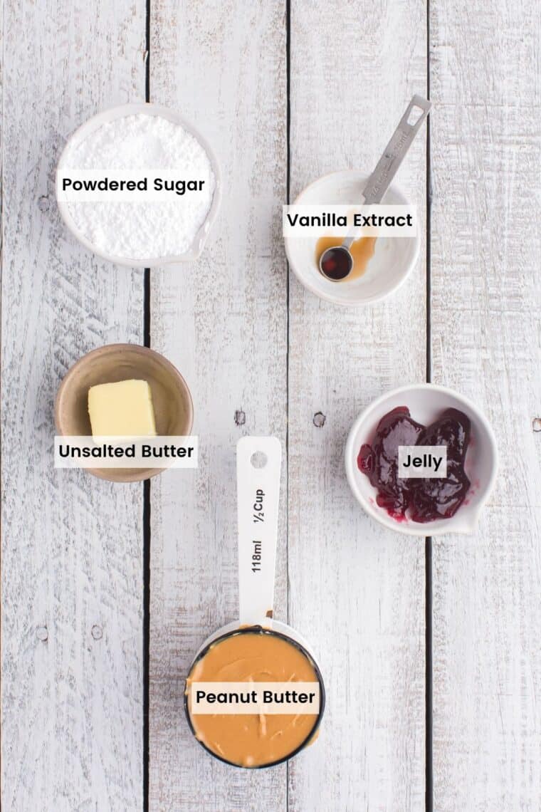 A measuring cup of peanut butter and bowls with a pat of butter, vanilla extract, powdered sugar, and jelly with text labels.