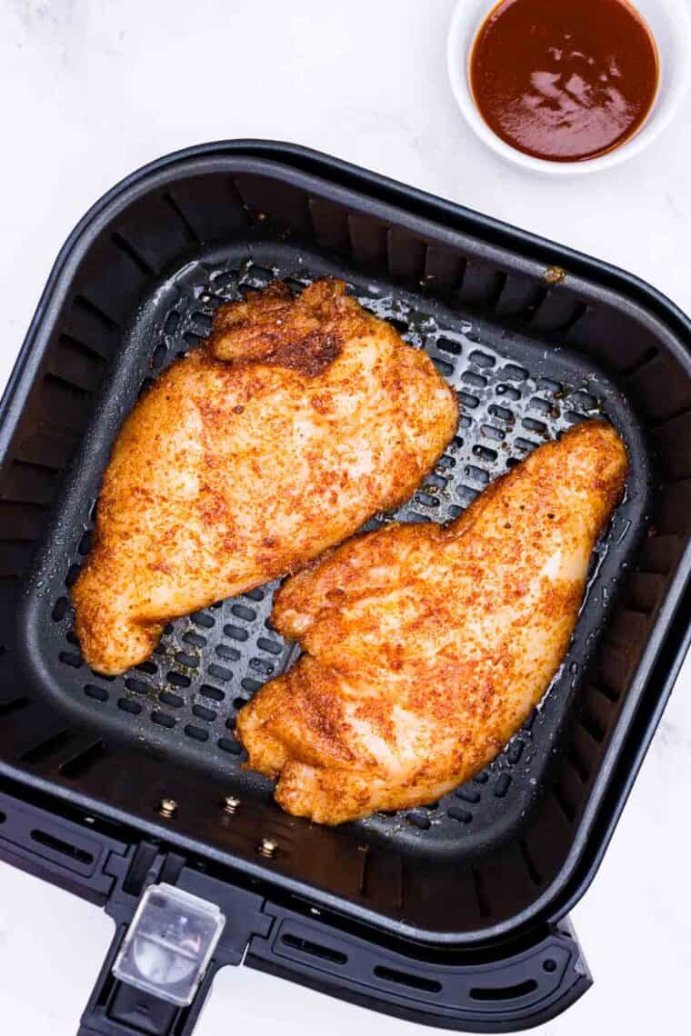 Seasoned chicken breasts in the air fryer.
