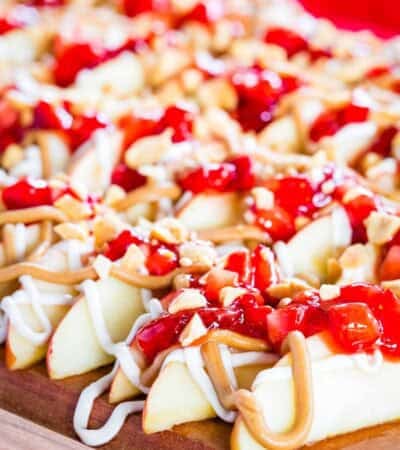 Apple nachos with jammy strawberries and peanut butter drizzle.