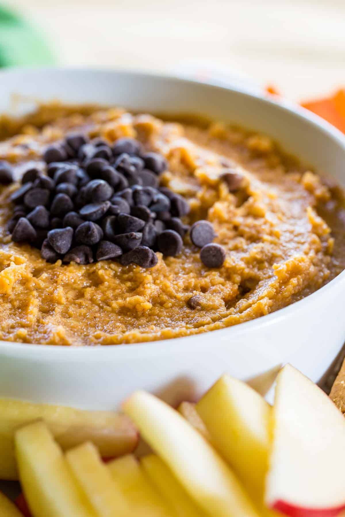Pumpkin hummus in a bowl with chocolate chips.