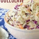 A bowl of slaw with a spoon next to it with text overlay that says "Apple Coleslaw".