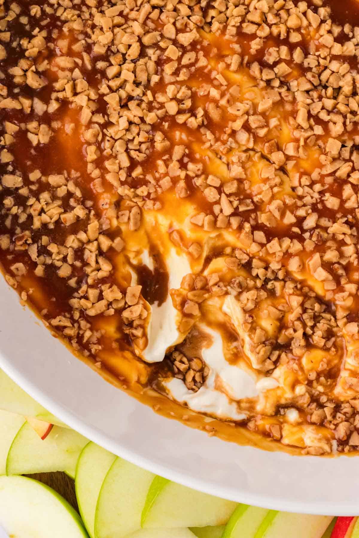 Overhead image of caramel apple dish with some scooped out of it.