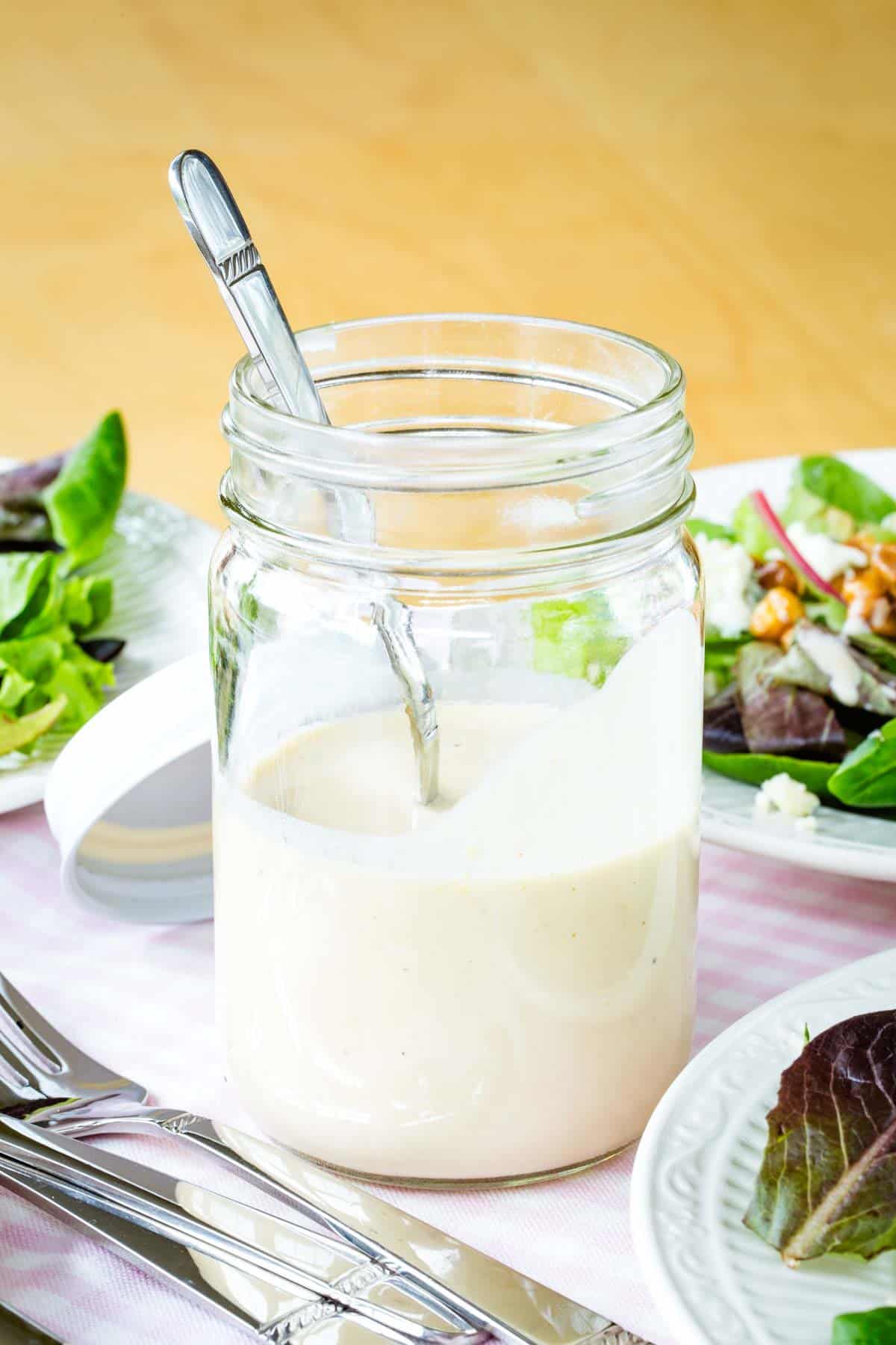 A jar of creamy sherry vinaigrette.
