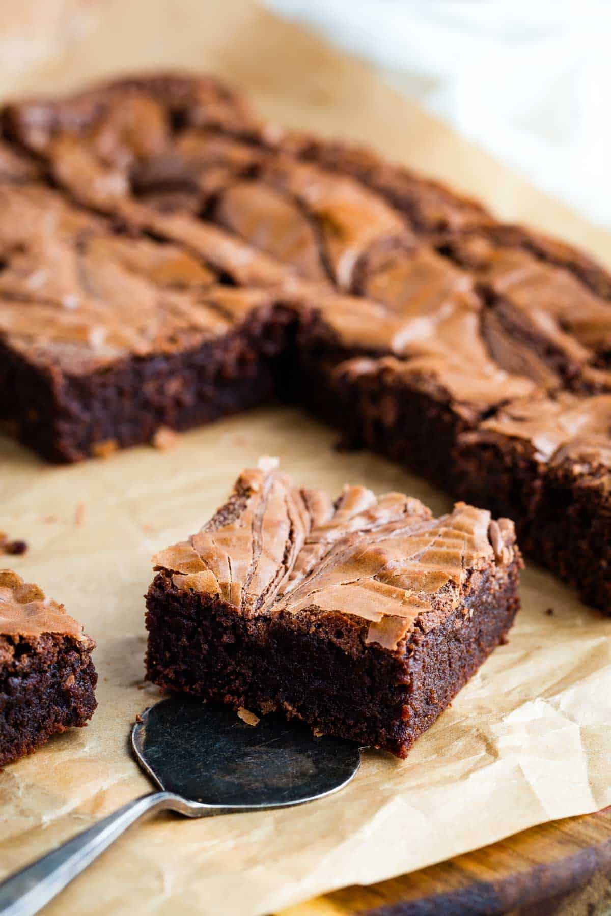 Nutella brownies sliced on a piece of parchment paper.