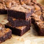 A stack of 3 Nutella brownies on parchment paper.