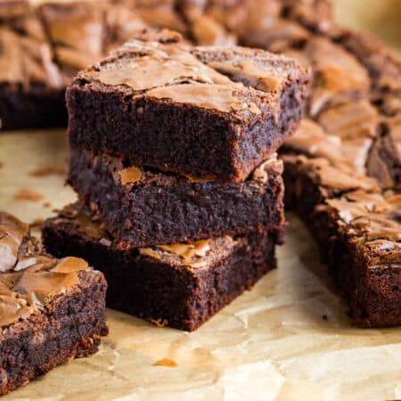 A stack of 3 Nutella brownies on parchment paper.