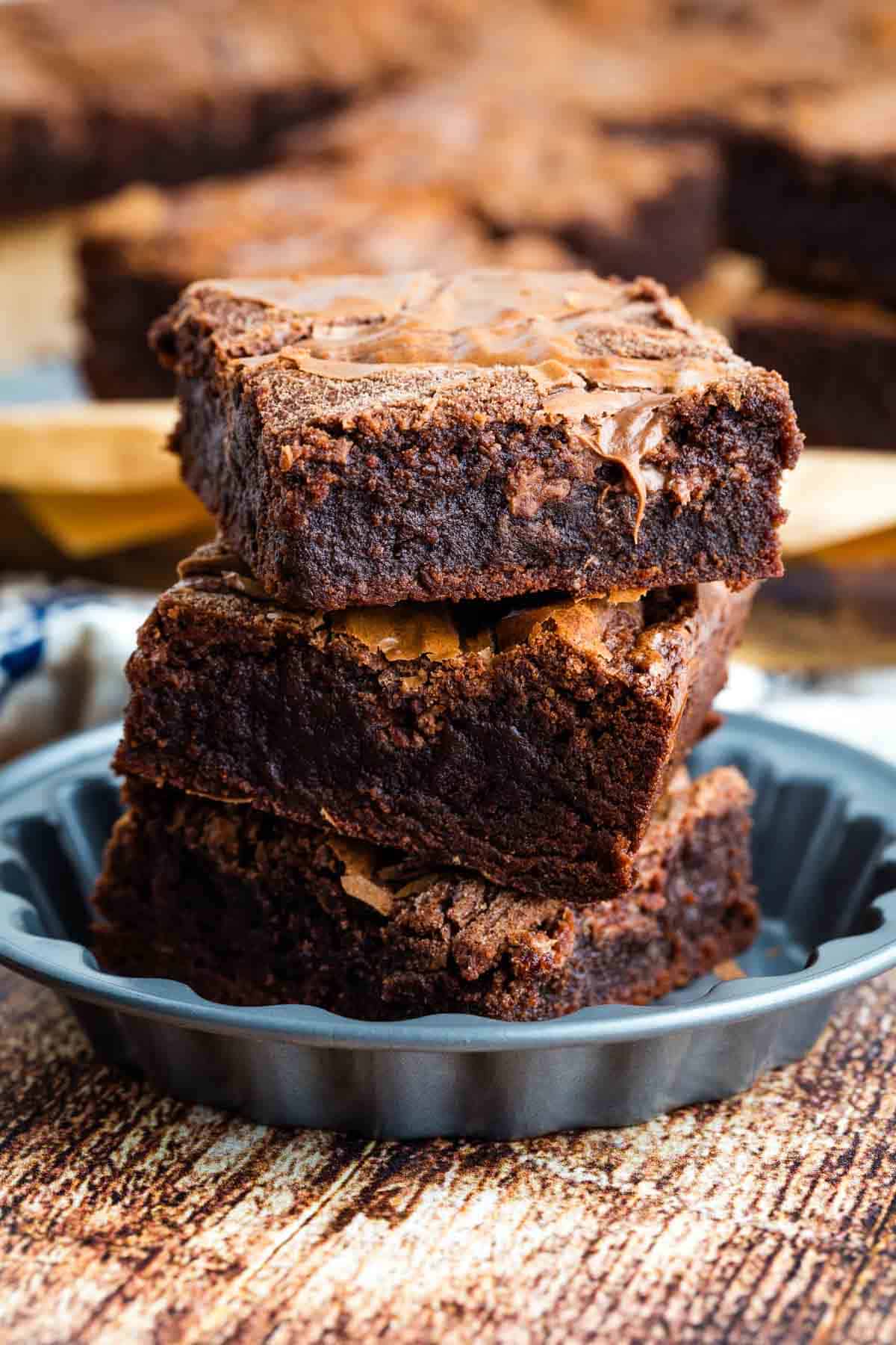 A stack of three Nutella brownies in a mini pie pan.