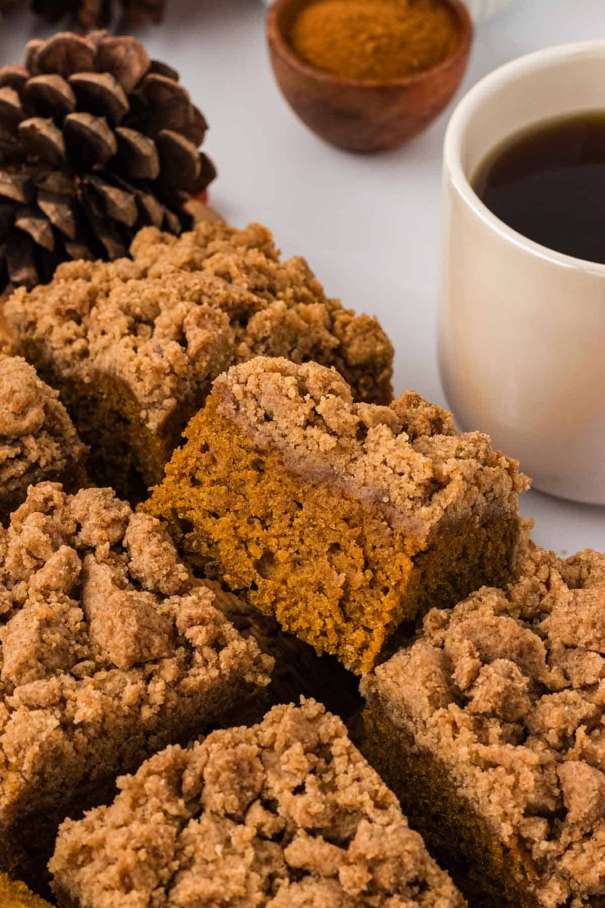 Pumpkin crumb coffee cake cut into squares.