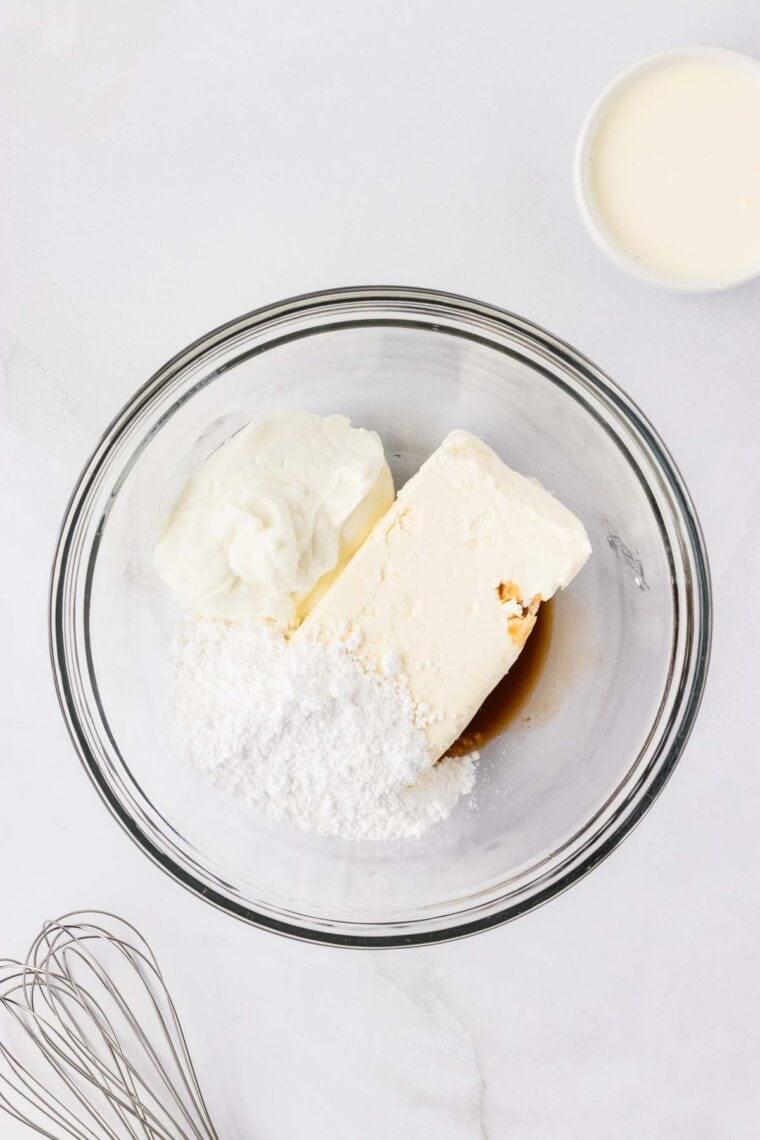 Cream cheese, Greek yogurt, powdered sugar, and vanilla in a mixing bowl.