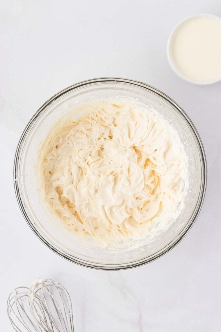 Cream cheese, Greek yogurt, powdered sugar, and vanilla beat until smooth in a mixing bowl.