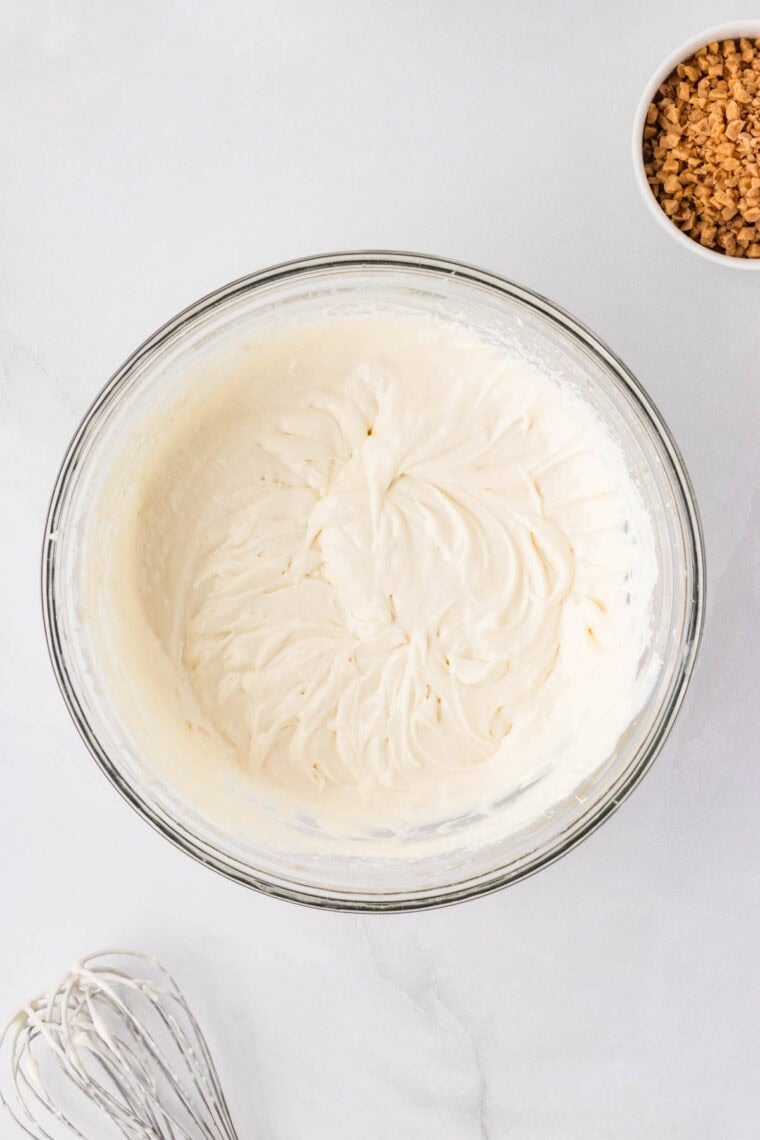 A bowl full of the creamy base from caramel apple dip.