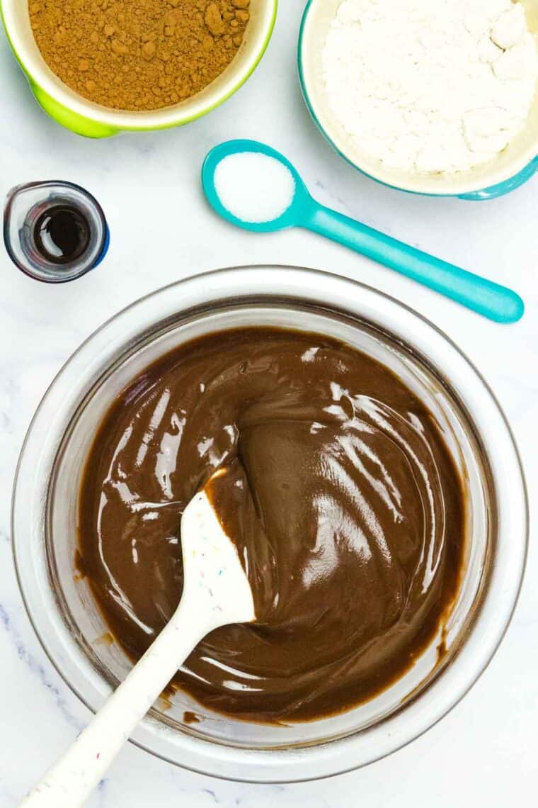 Mixing together melted butter and Nutella.