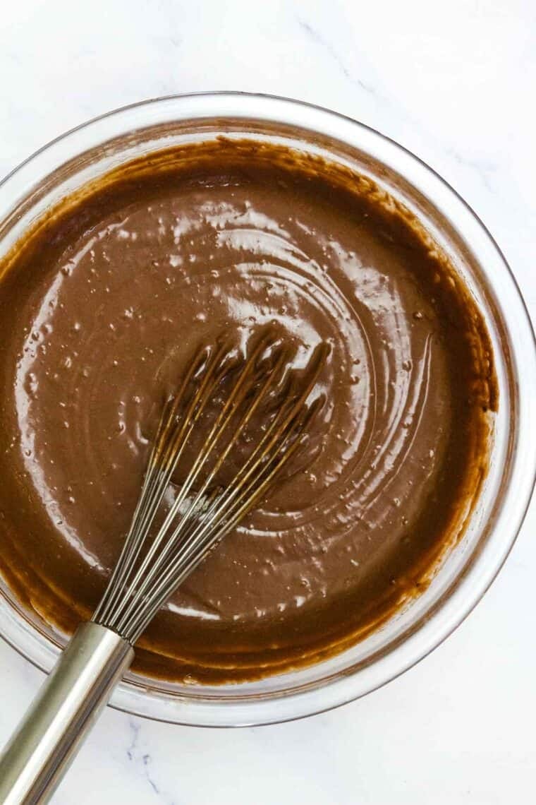 Nutella brownie batter in a bowl with a whisk.