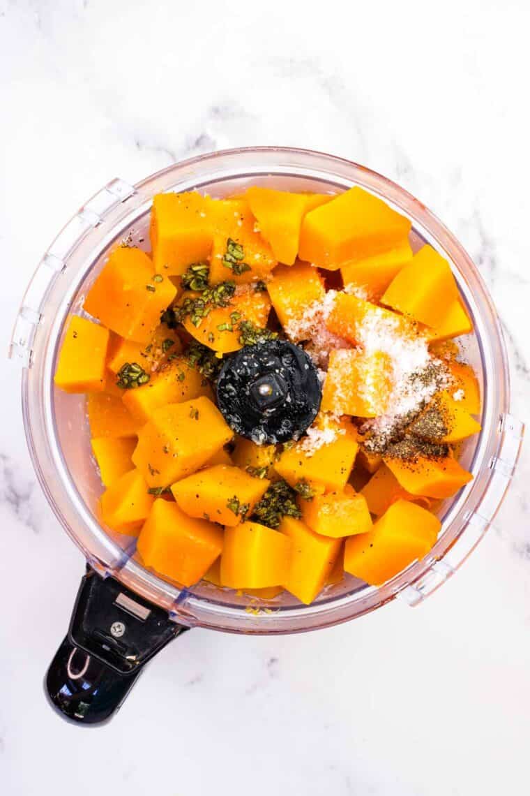 Steamed butternut squash, sage butter, kosher salt, and pepper in a food processor.