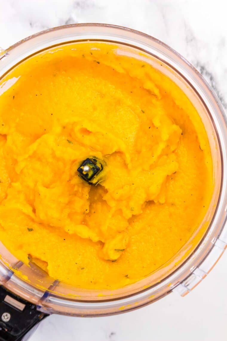 Pureed butternut squash in a food processor.