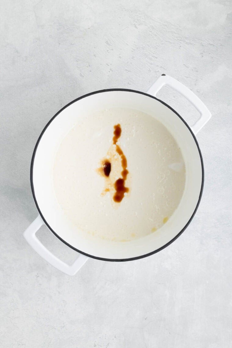 Adding vanilla and salt to melted mini marshmallows and butter.