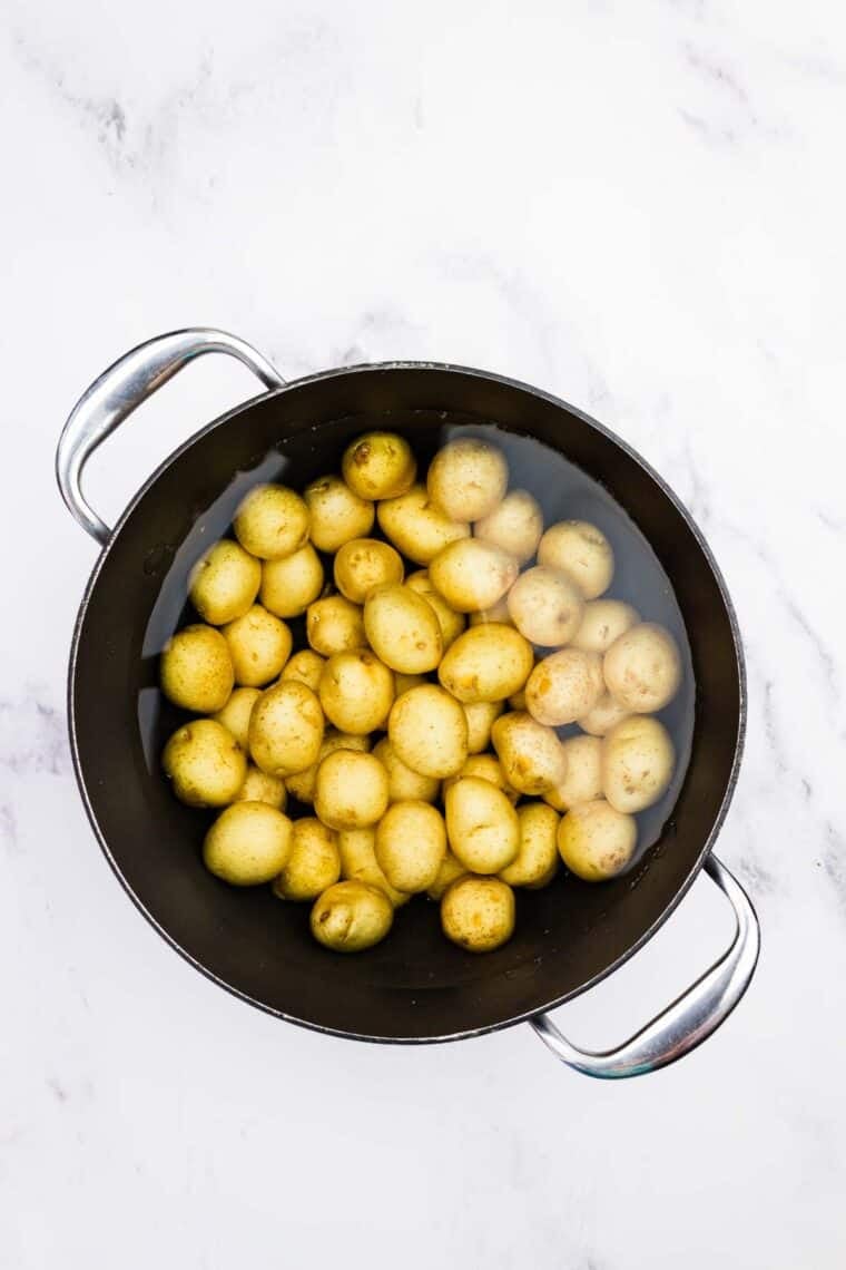 Creamer potatoes in a pot with water.