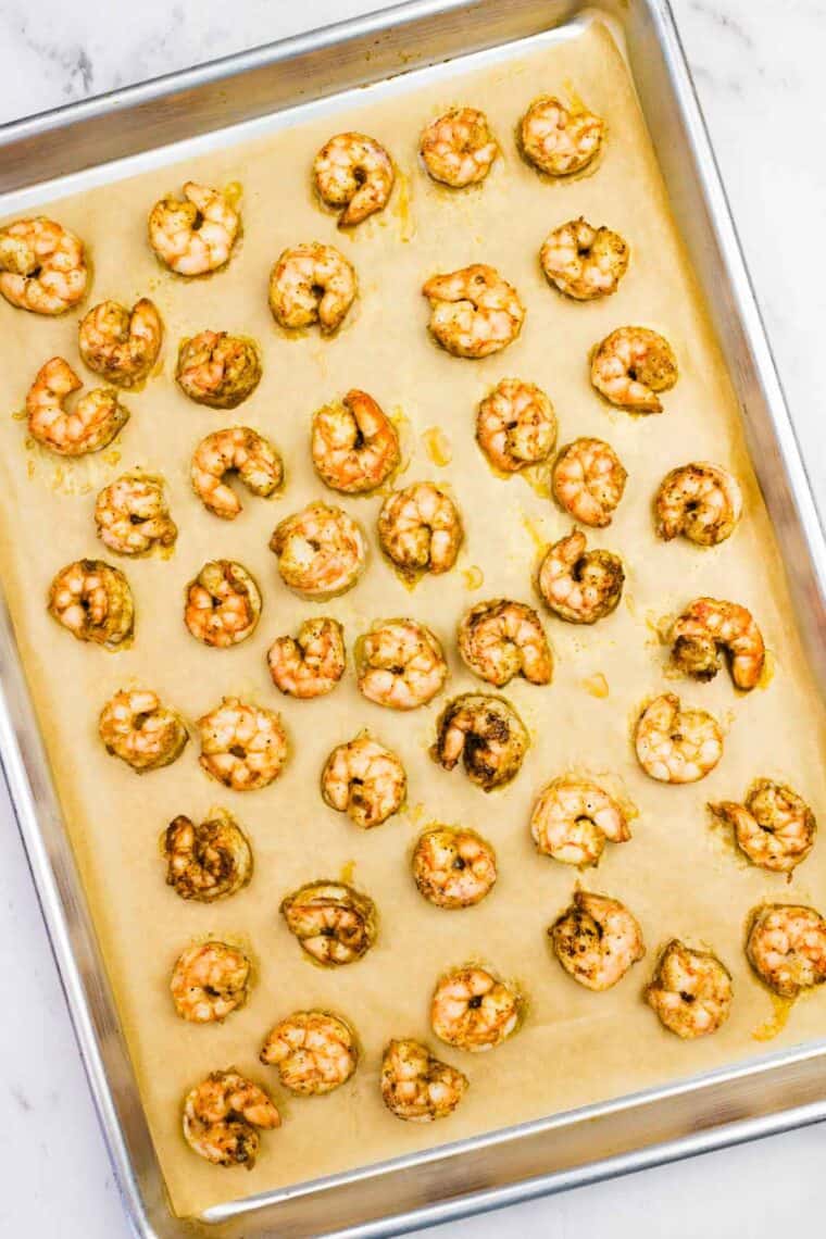 Baked shrimp on a sheet pan.
