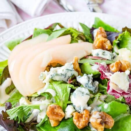 Poached pear salad with honeyed walnuts and crumbled gorgonzola.