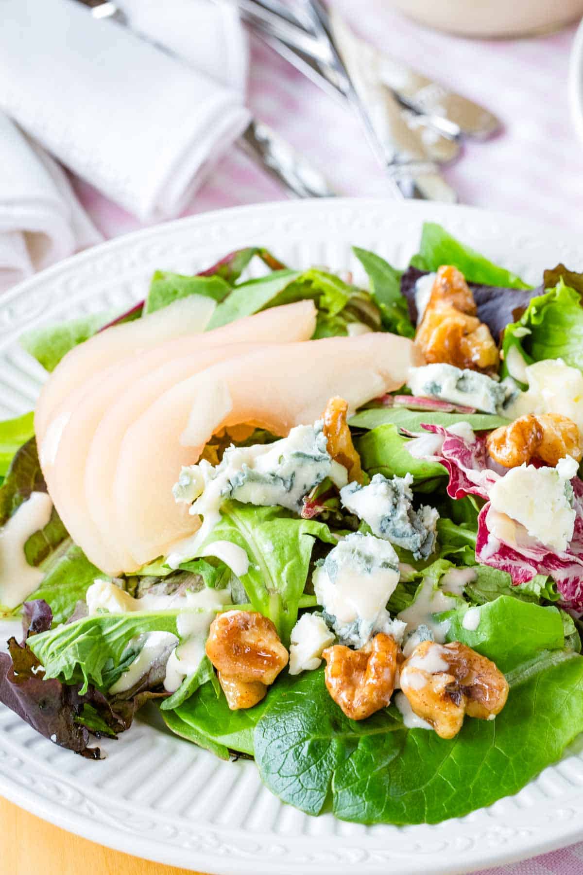 Poached pear salad with honeyed walnuts and crumbled gorgonzola.