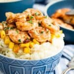 Shrimp and mashed potatoes in a blue bowl.