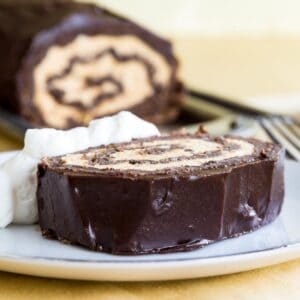A slice of Flourless Chocolate Pumpkin Roll on a plate.