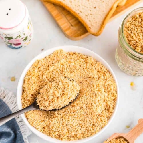Overhead image of gluten free breadcrumbs in a bowl with a spoon.