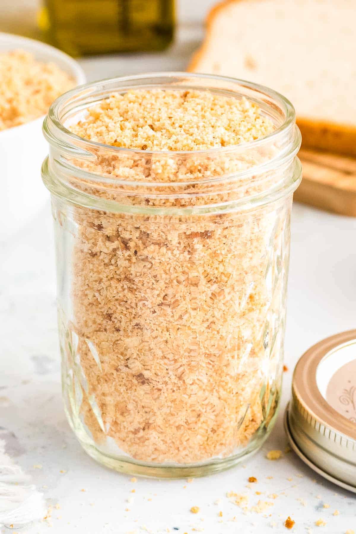 A mason jar full of gluten free breadcrumbs.