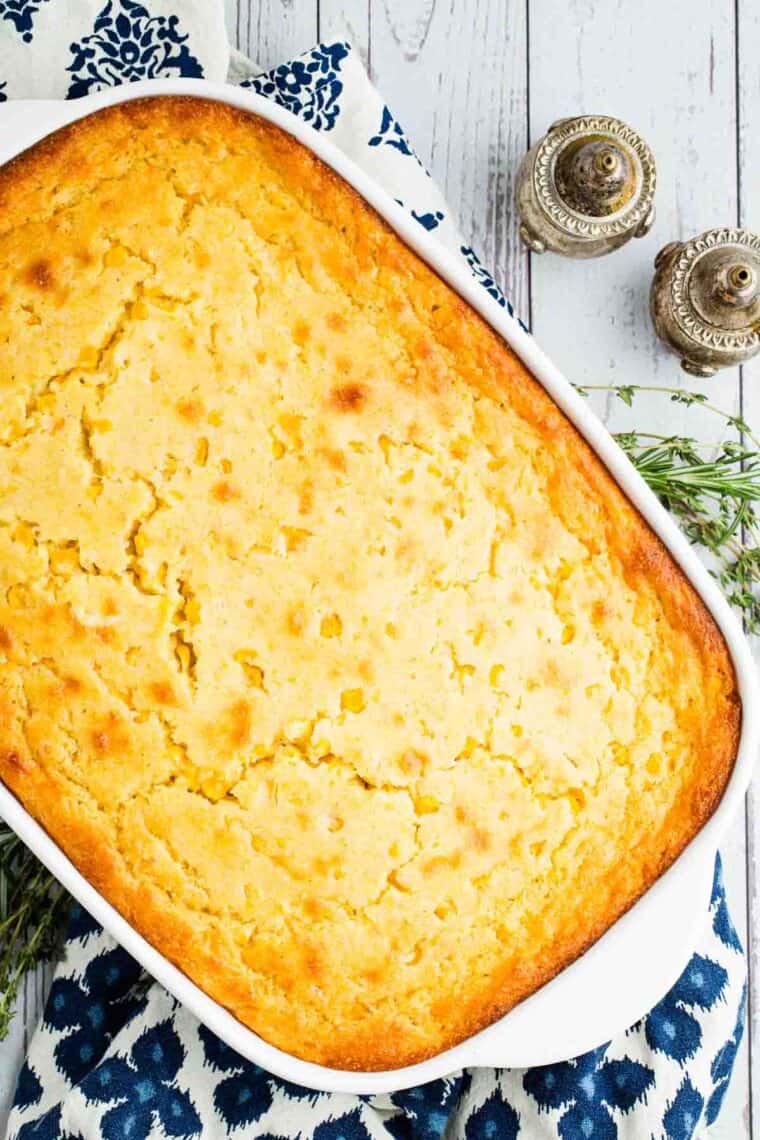 This wildly easy gluten-free corn casserole combines sweet and savory goodness with a creamy texture that’s guaranteed to be a hit. Overhead image of gluten free corn casserole in a baking dish.