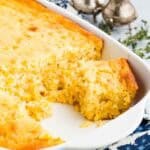 Corn casserole with several servings removed.
