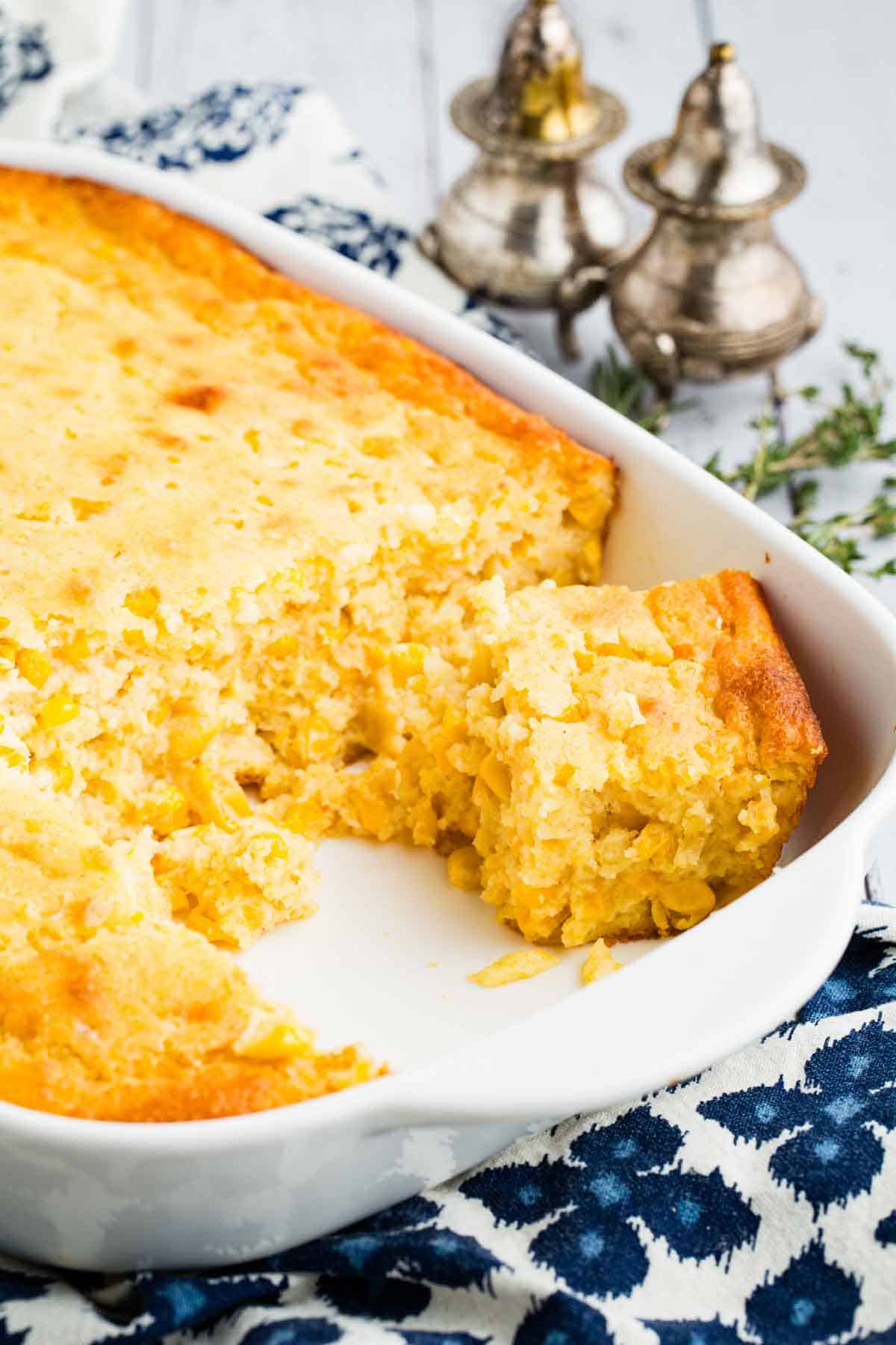 Corn casserole with several servings removed.