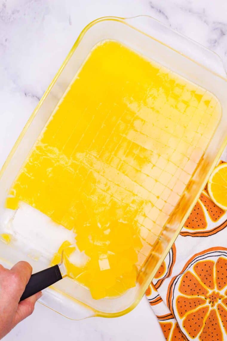 Cutting orange jello into cubes.