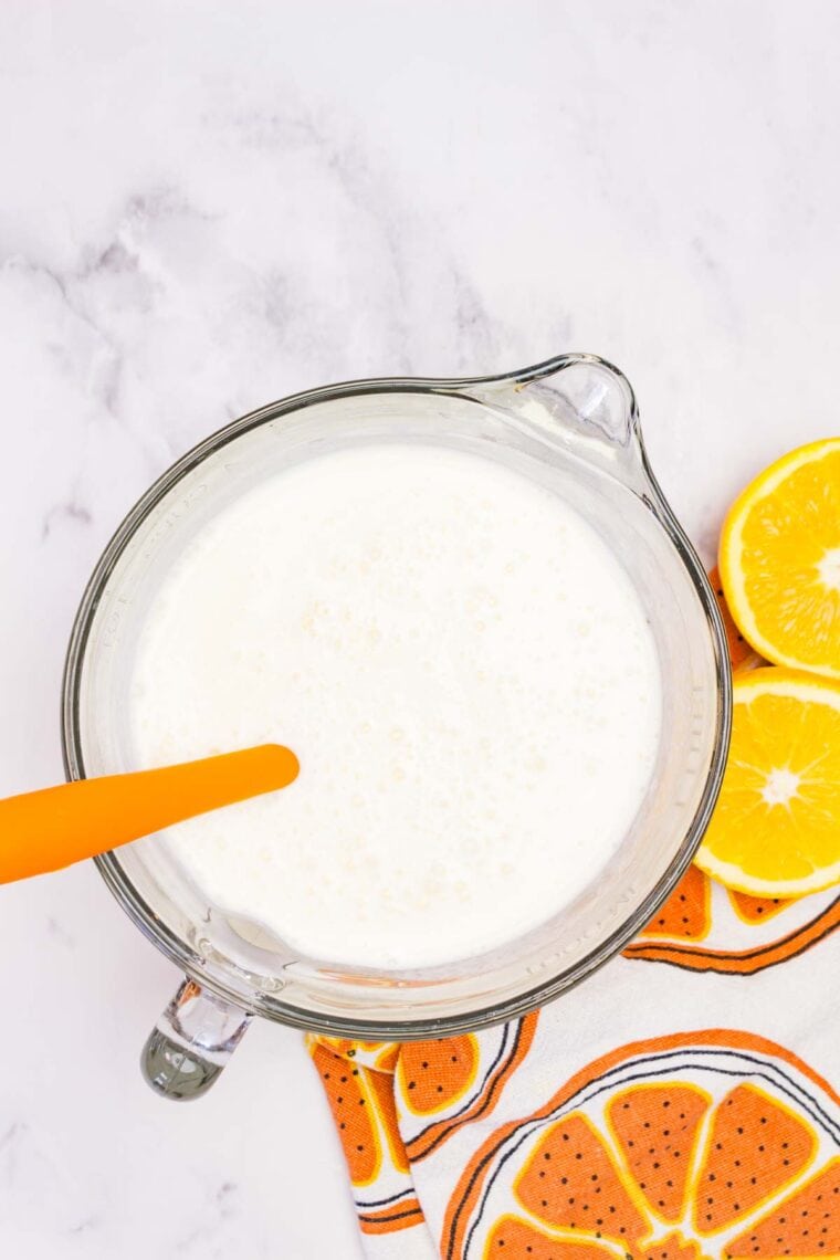 Mixing melted vanilla ice cream into gelatin that's been dissolved in hot water.