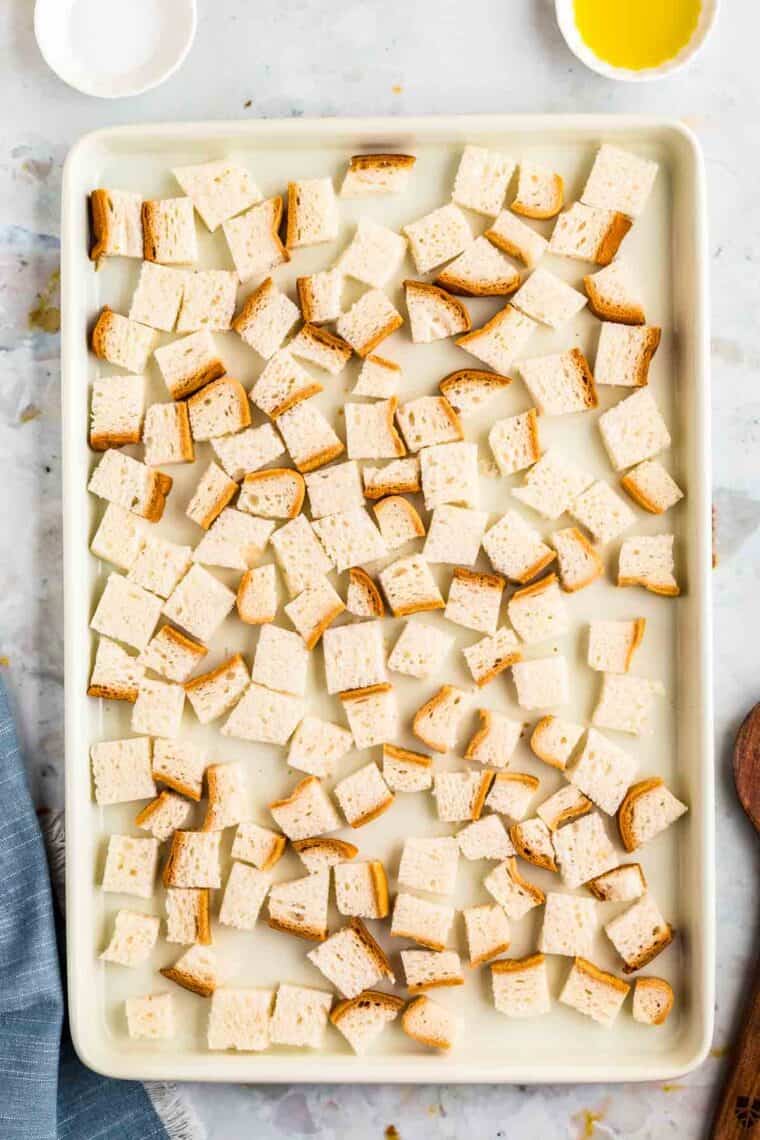 Bread cubes on a sheet pan.
