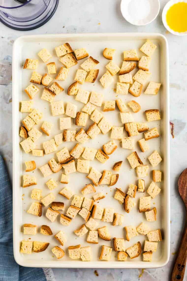 Dried bread cubes on a sheet pan.