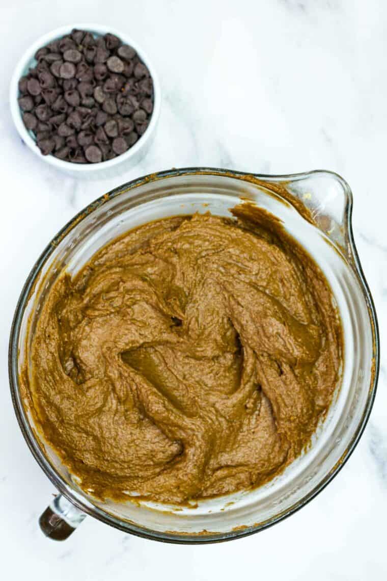 Combining the wet and dry ingredients for chocolate pumpkin cake batter.