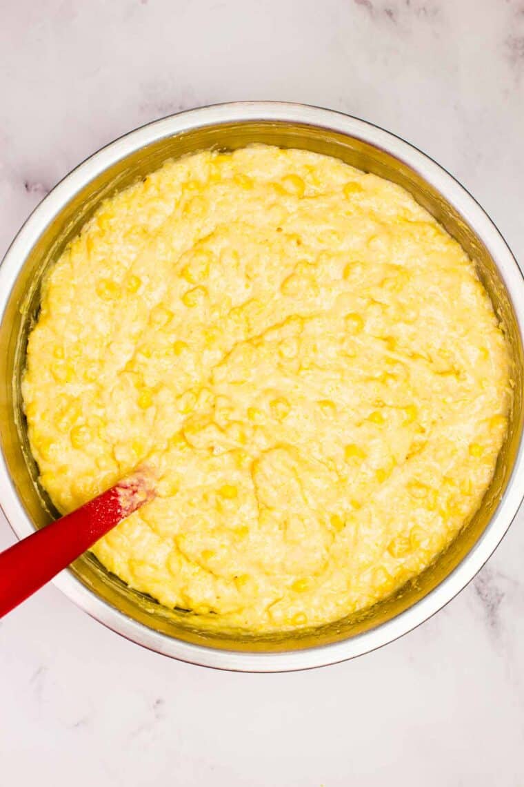 This wildly easy gluten-free corn casserole combines sweet and savory goodness with a creamy texture that’s guaranteed to be a hit. Gluten free corn casserole batter in a mixing bowl.
