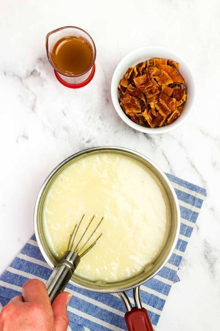 Thickening hot bacon dressing in a saucepan. 