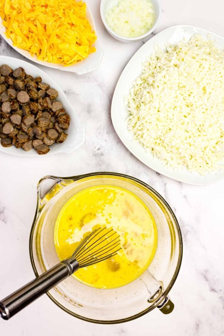 Eggs, milk, dry mustard, salt, and pepper beaten together in a measuring cup.