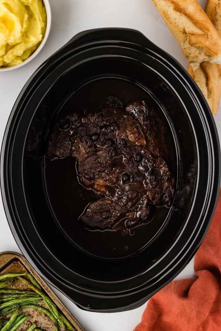 Slow cooker balsamic beef is the answer to your holiday hosting dreams, delivering melt-in-your-mouth beef in a tangy, subtly sweet sauce. Balsamic beef in a slow cooker, ready to be shredded.