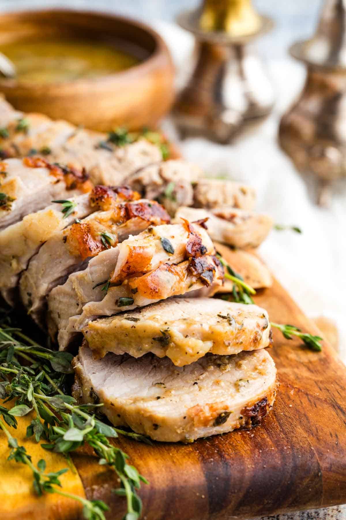 This bourbon pork tenderloin delivers tender, juicy meat with a mouthwatering maple-bourbon glaze. It'll change the way you think about pok! Sliced bourbon pork tenderloin on a cutting board.