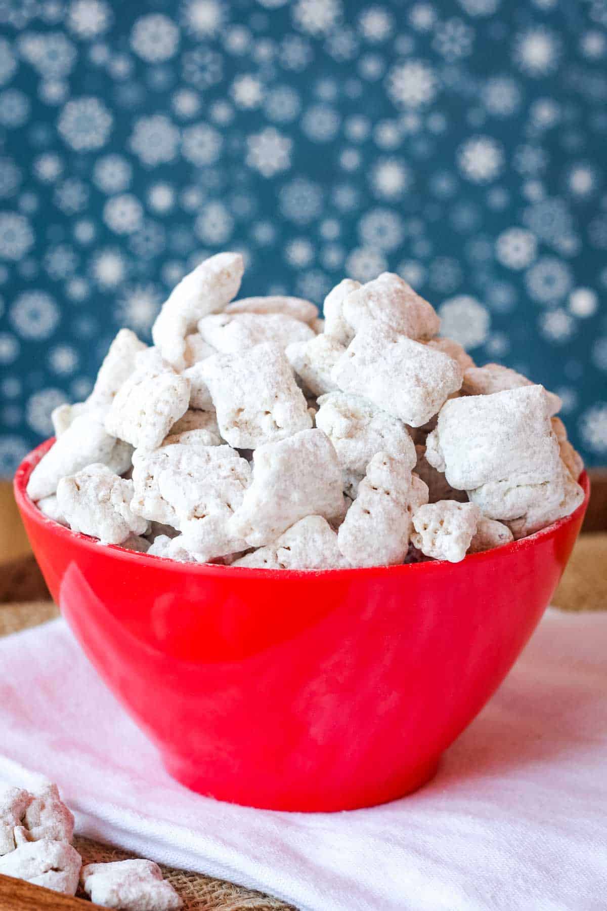 A white bowl full of Chai White Chocolate Muddy Buddies.
