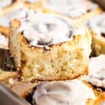 A spatula holding a gluten-free chocolate cinnamon roll up to the camera.