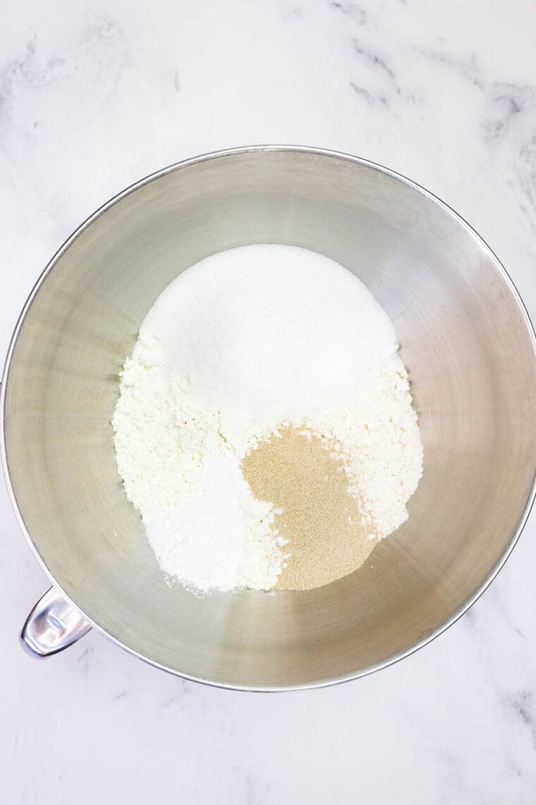 The dry ingredients for cinnamon roll dough in a bowl.