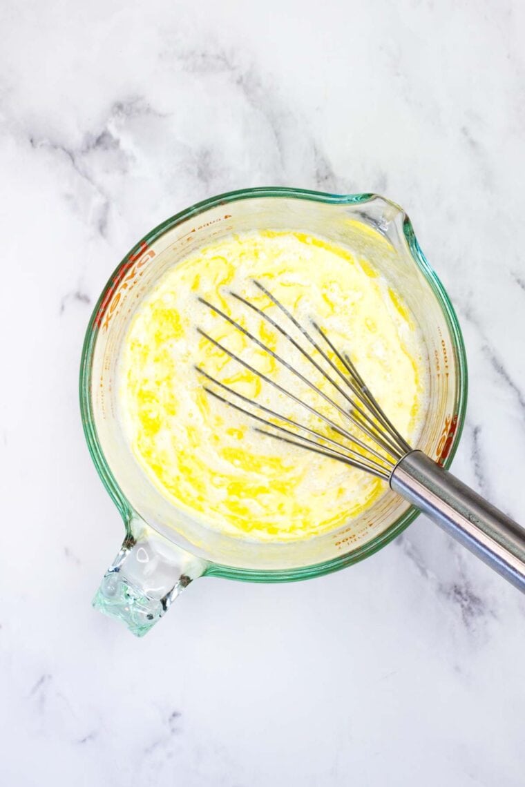 Mixing together milk, butter, and eggs for cinnamon roll dough.