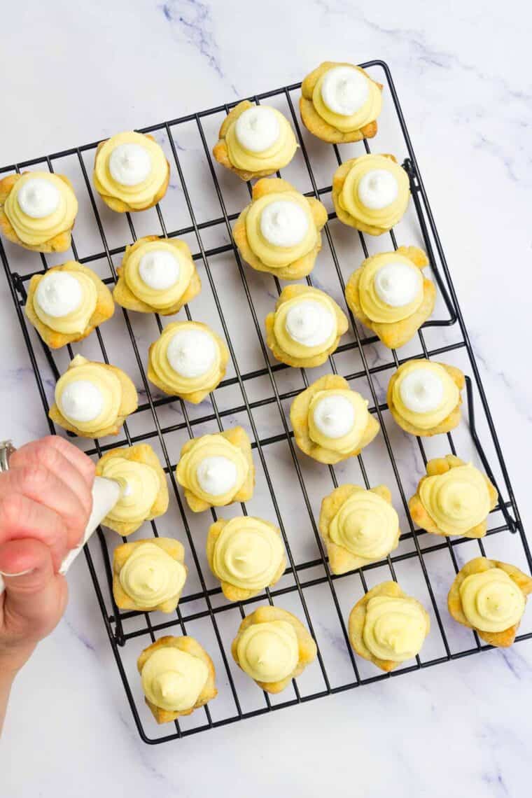 Topping mini eggnog pies with Cool Whip.