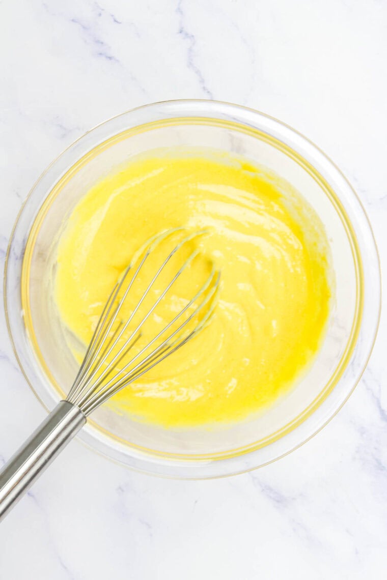 Whisking together instant vanilla pudding mix and eggnog.