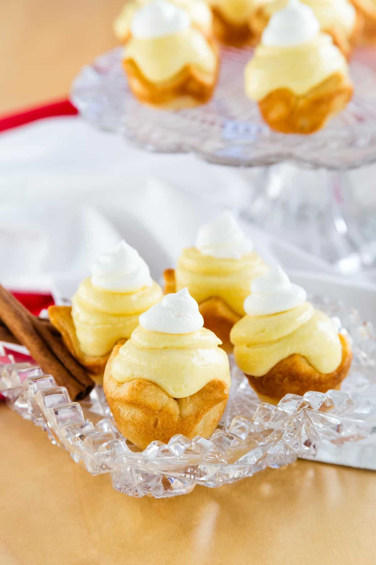 Gluten-free eggnog pies on a serving plate with cinnamon sticks.